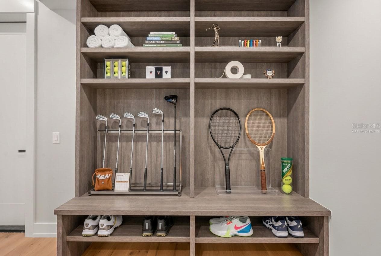 Virtually staged mudroom entry featuring custom built-ins with abundant storage for an active lifestyle. - 3360 BAYOU SOUND, LONGBOAT KEY