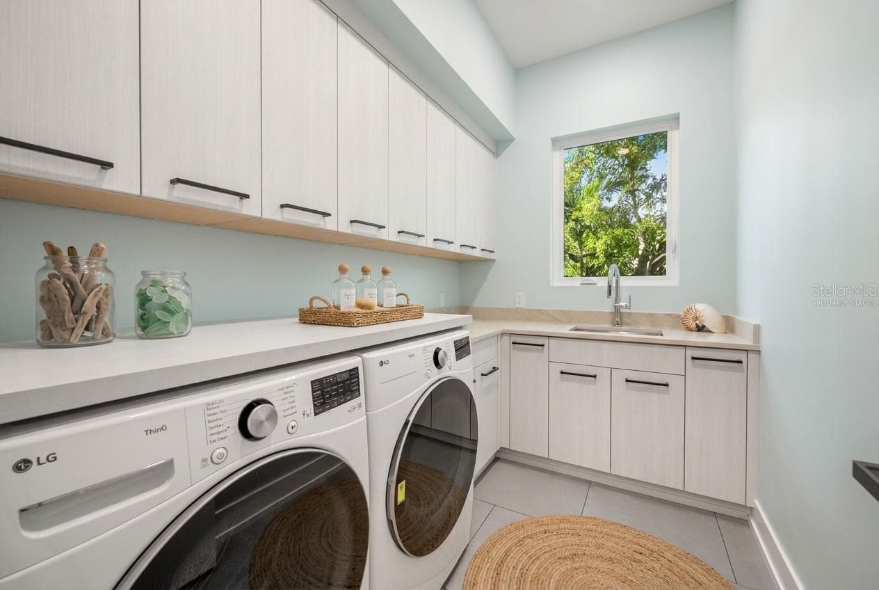 Virtually staged first-floor laundry room offering generous workspace, storage, and everyday convenience. - 3360 BAYOU SOUND, LONGBOAT KEY