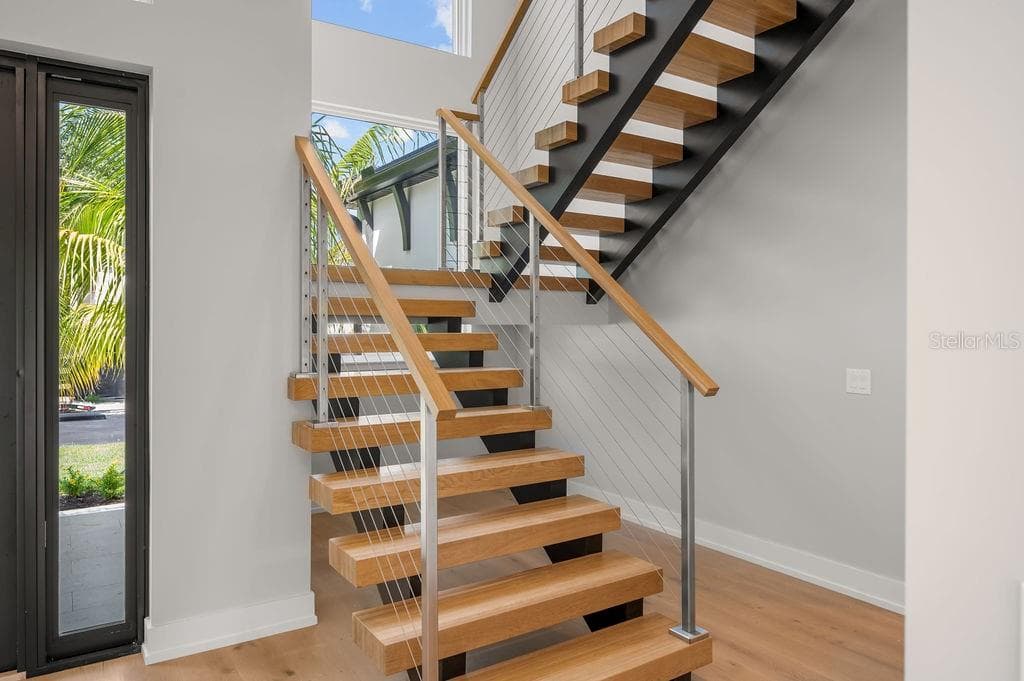 Custom designed staircase leading to second floor leading to 3 additional en suite bedrooms. - 3360 BAYOU SOUND, LONGBOAT KEY