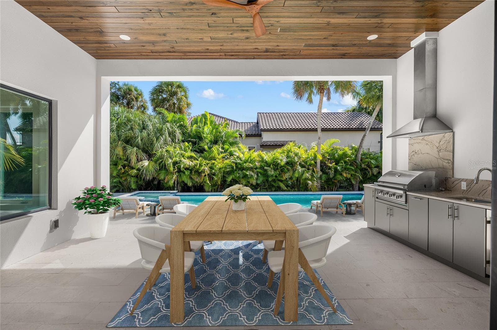 Virtually staged, paradise awaits in the under roof outdoor entertaining area with built in luxury kitchen. - 3360 BAYOU SOUND, LONGBOAT KEY