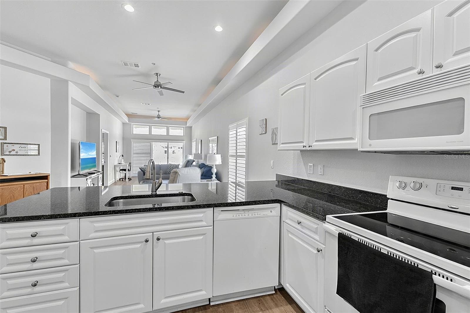 Kitchen looking out to the patio through the great room - 101 NATURES WAY #1307, ROTONDA WEST