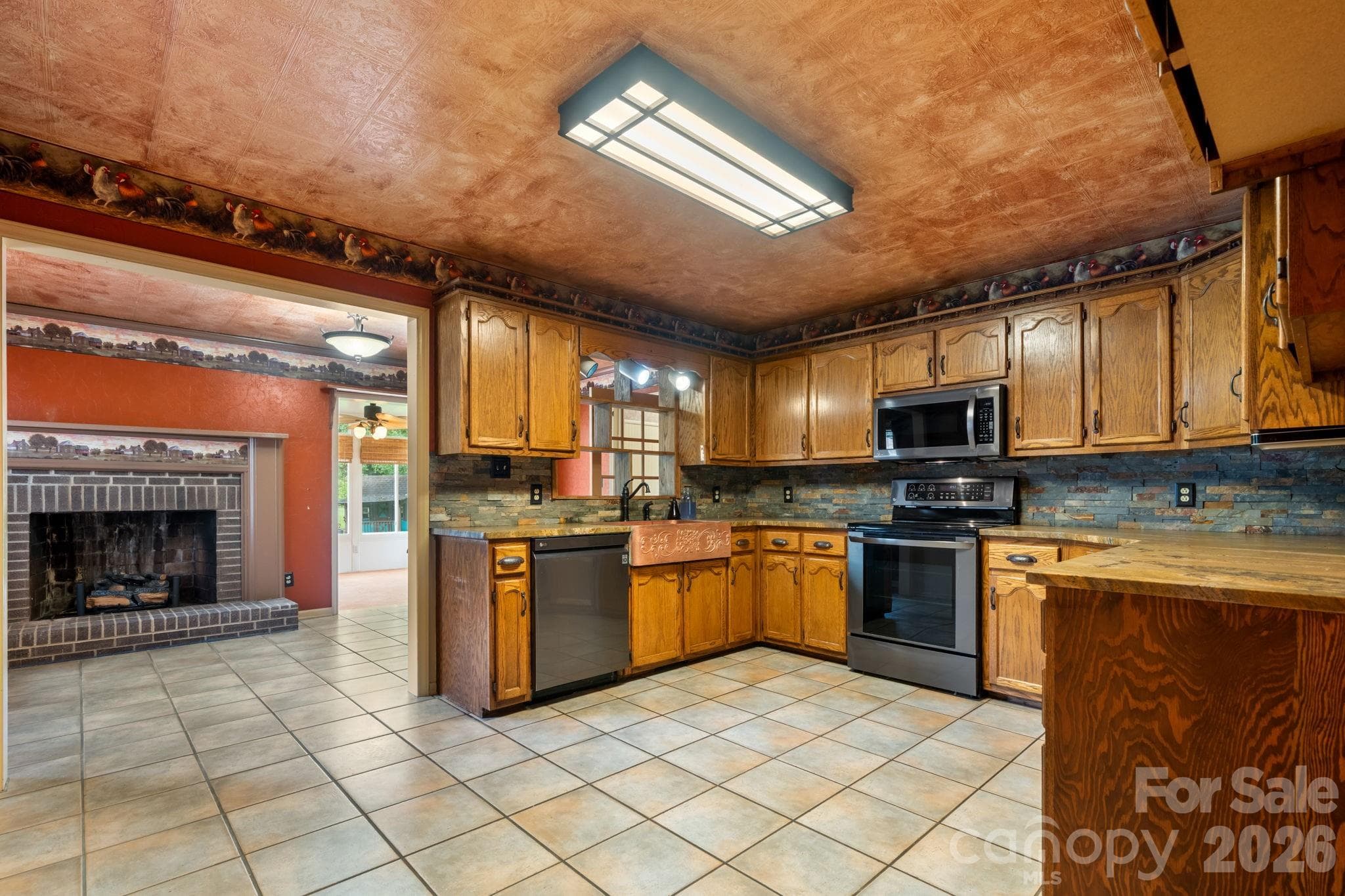 kitchen view to den that leads into sunroom and mudroom/laundry room - 3110 Ninth Tee Drive, Newton