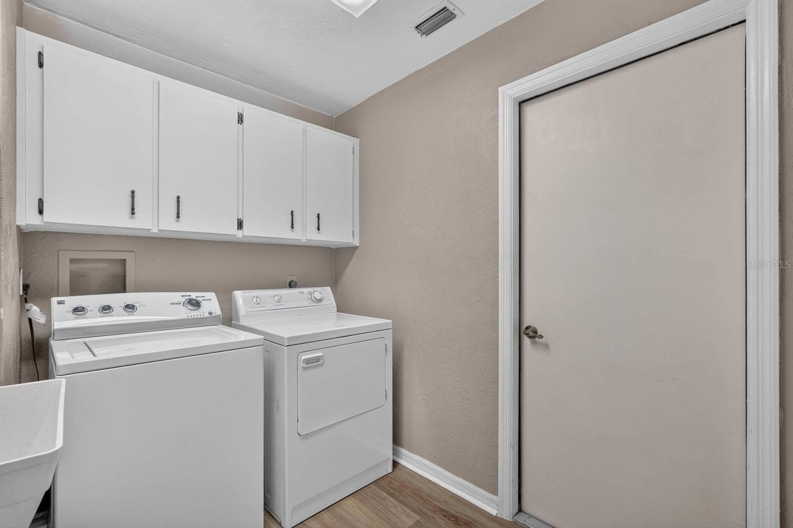Laundry room has storage cabinetry and utility sink - 156 BRESSLER LN, PALM COAST
