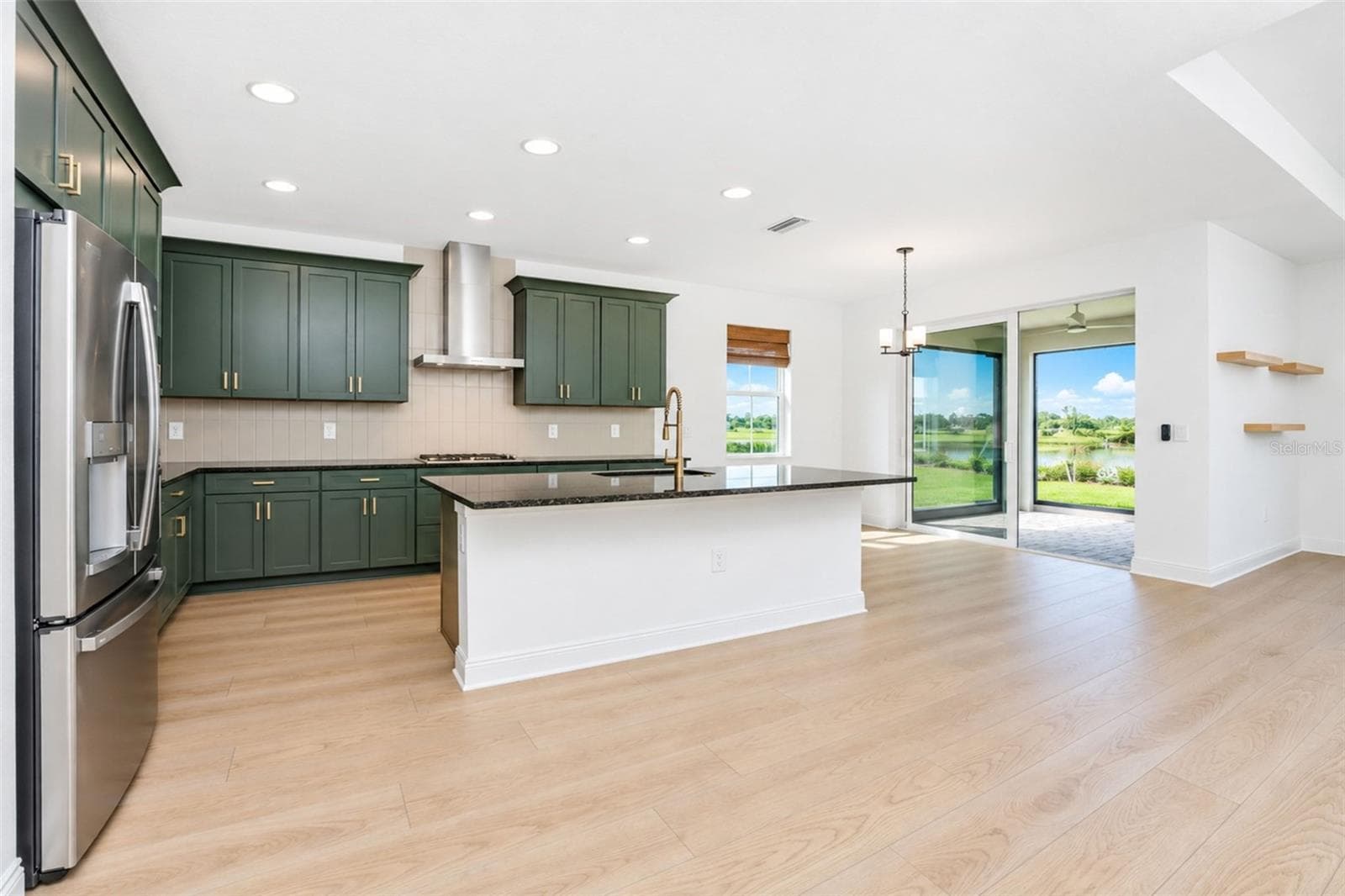 Open-concept main living area seamlessly connecting the kitchen, dining and living spaces. - 237 VISTERA BLVD, NOKOMIS