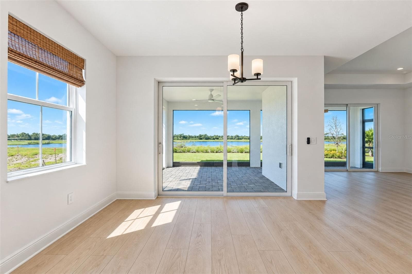 Tinted hurricane-impact sliding glass doors provide added storm protection while helping reduce heat and glare - 237 VISTERA BLVD, NOKOMIS