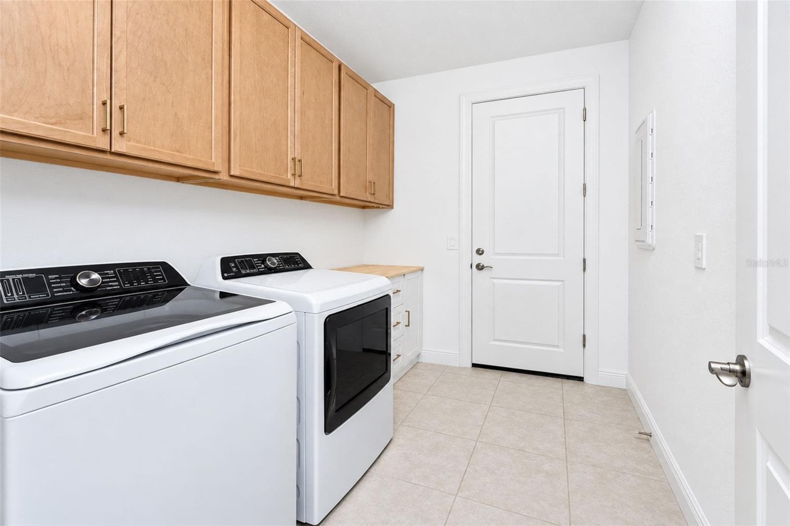 Spacious laundry room with an abundant of upper cabinetry and convenient access to the garage - 237 VISTERA BLVD, NOKOMIS