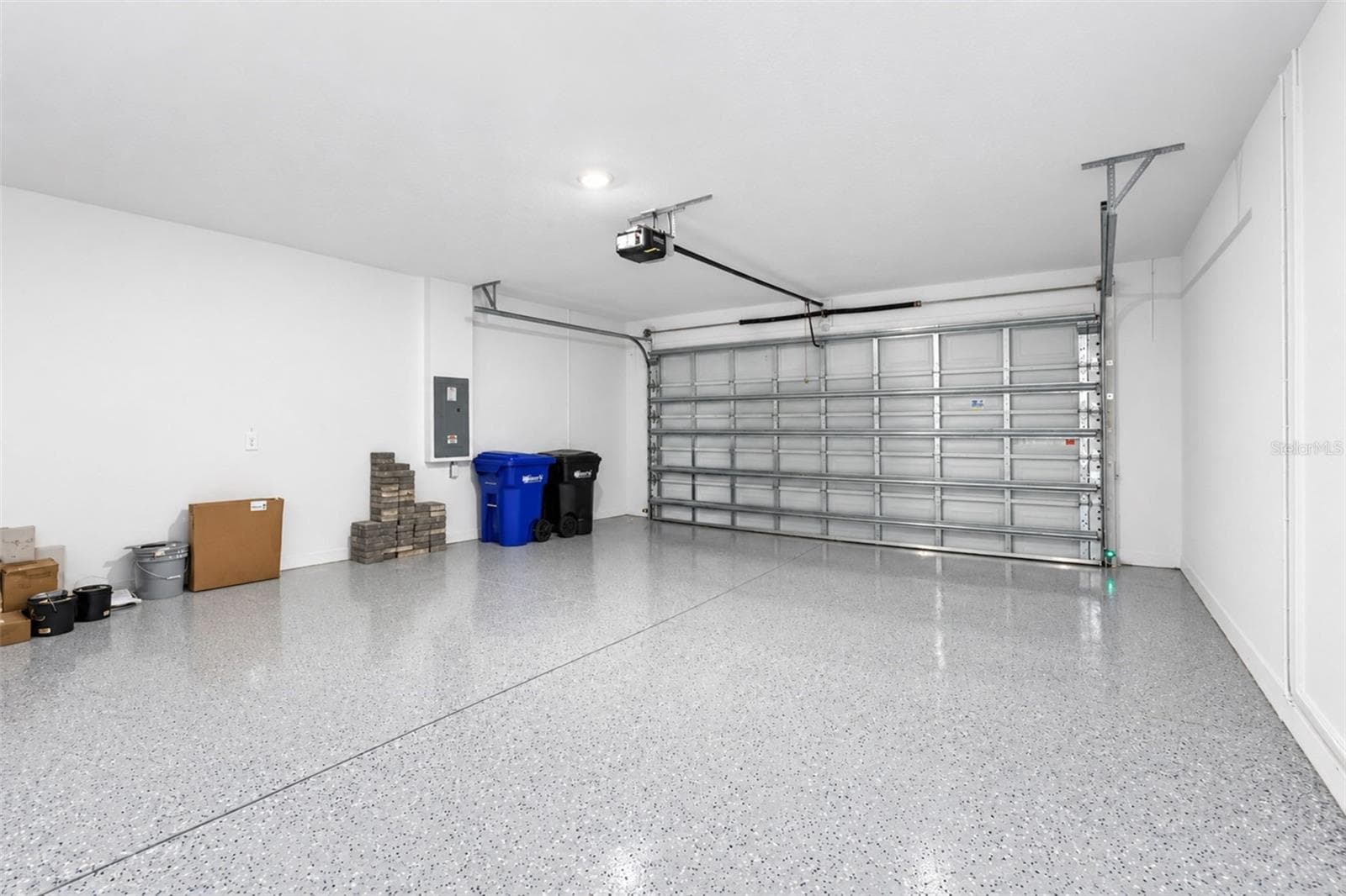 Spacious 2-car garage measuring approximately 19.8' x 20.4', featuring a durable epoxy-coated floor - 237 VISTERA BLVD, NOKOMIS