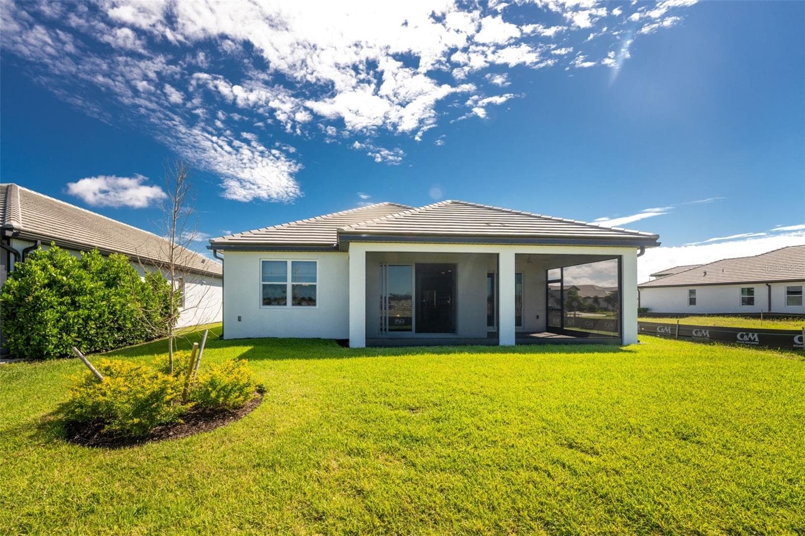 Rear Exterior — tile roof, oversized screened lanai, sliding-glass access to the lanai, and spacious backyard. - 237 VISTERA BLVD, NOKOMIS