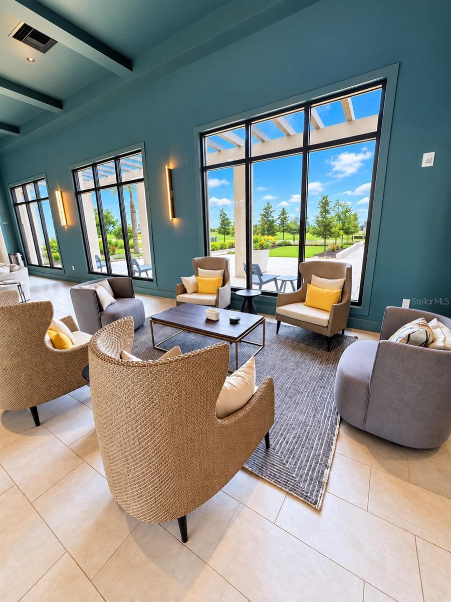 Beautifully appointed gathering space with comfortable seating, expansive windows, and views of the lush community grounds. - 237 VISTERA BLVD, NOKOMIS