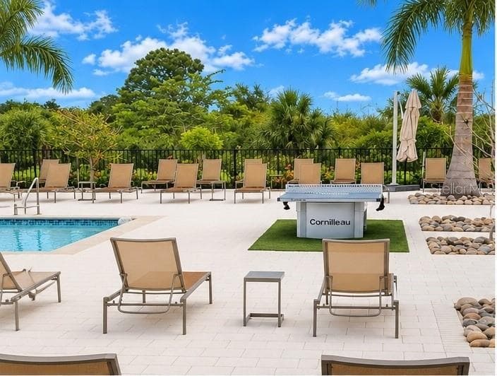 Inviting pool area featuring ample lounge seating and a ping pong table for outdoor recreation and entertainment. - 237 VISTERA BLVD, NOKOMIS