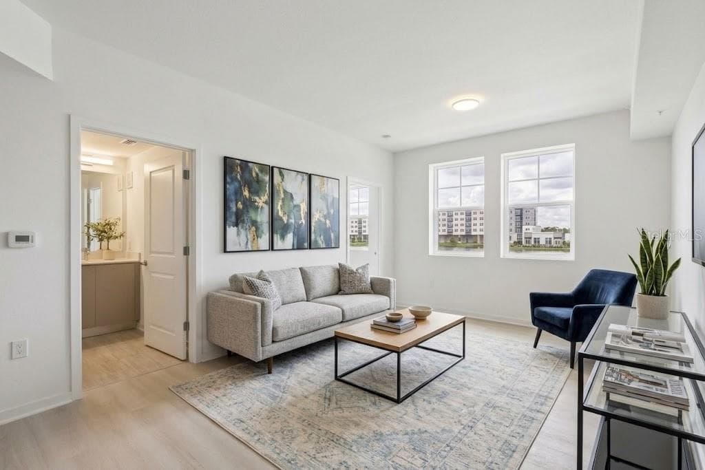 Open living room with water view - 5587 MILLENIA PARK BLVD #203, ORLANDO