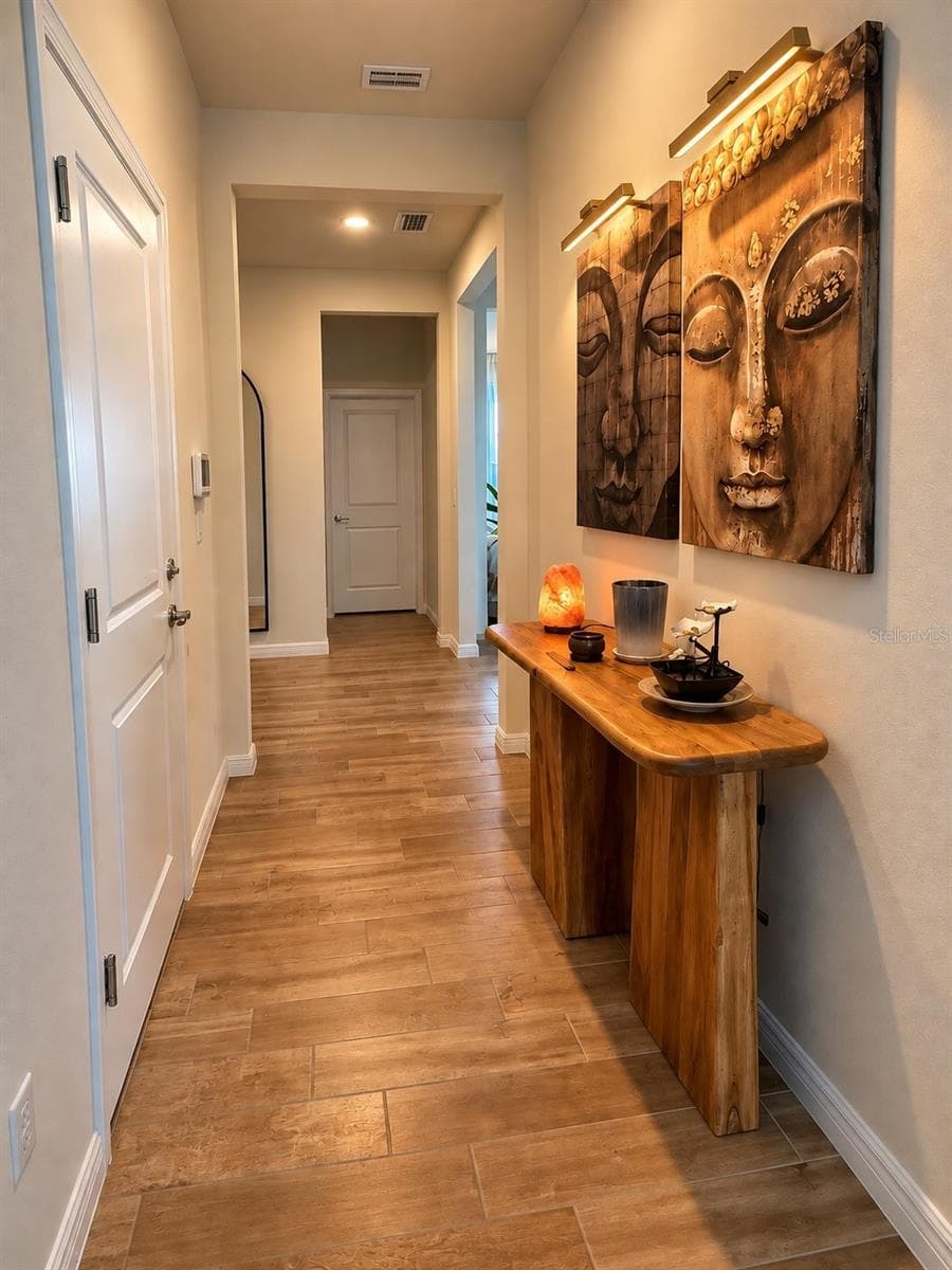 Hallway with direct access to the garage and main living areas. - 6735 REVERIE PARK AVE, ORLANDO