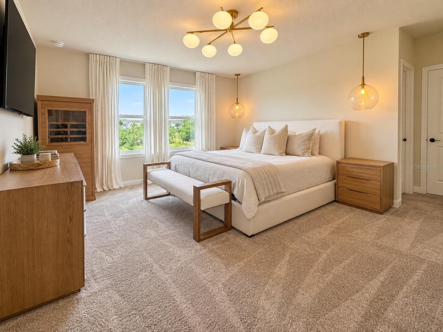 Spacious primary bedroom featuring abundant natural light, generous proportions, and a bright, serene atmosphere with ample room for a king-size bed and additional furnishings. - 6735 REVERIE PARK AVE, ORLANDO