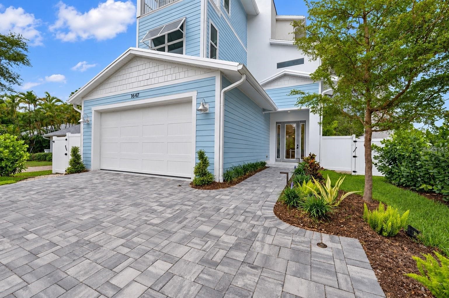 A gate enclosure has since been added for the front door pathway, to create more privacy - 1647 SIESTA DR, SARASOTA