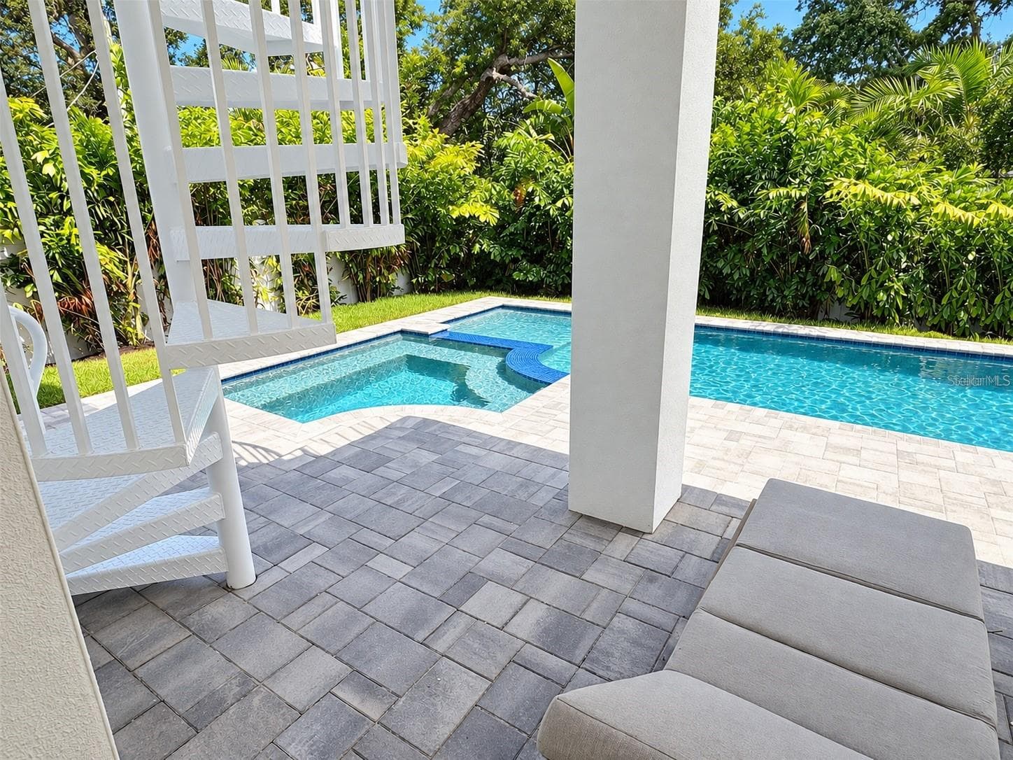 Spiral staircase leads to upstairs bedroom balconies - 1647 SIESTA DR, SARASOTA