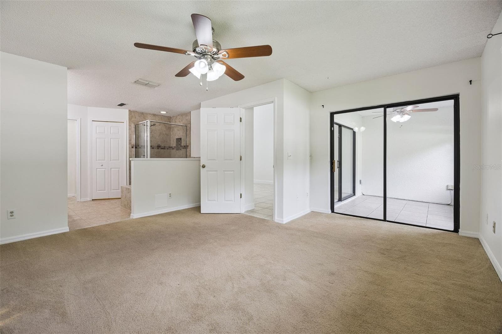 Primary bedroom with access to patio/lanai - 8370 SANDPOINT BLVD, ORLANDO