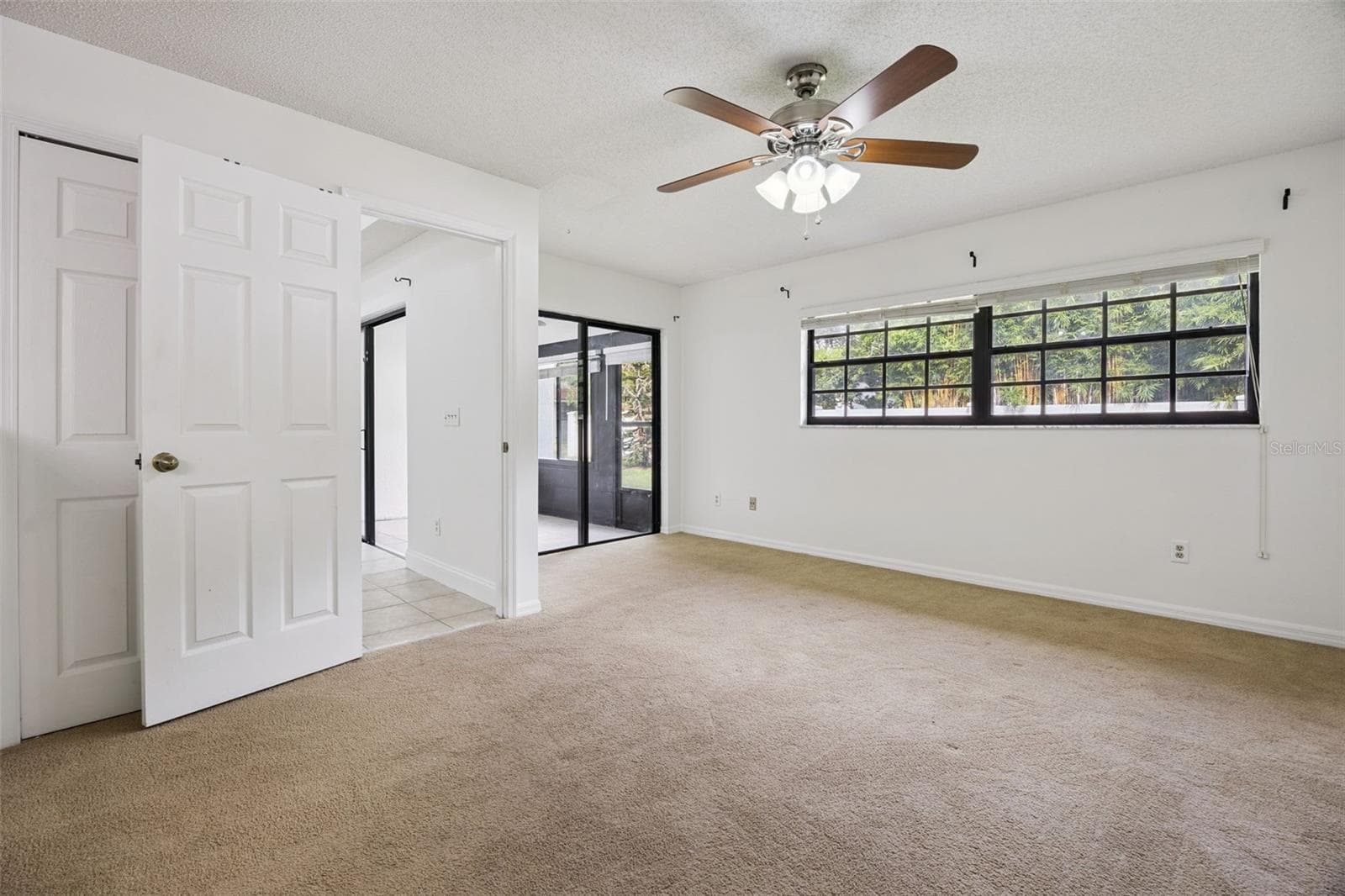 Primary bedroom with access to patio/lanai - 8370 SANDPOINT BLVD, ORLANDO