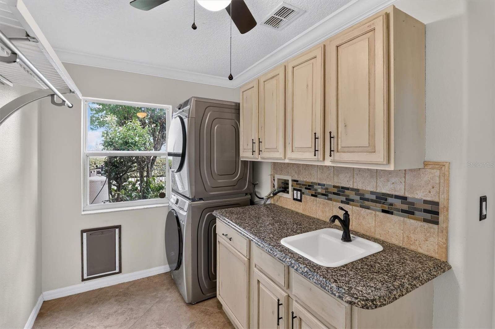 Laundry room with cabinetry, counter space and utility sink. - 2109 WEMBLEY PL, OVIEDO