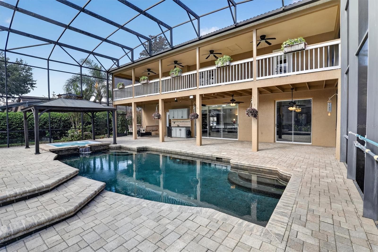 Wide view of the pool, upper balcony and rear elevation. - 2109 WEMBLEY PL, OVIEDO