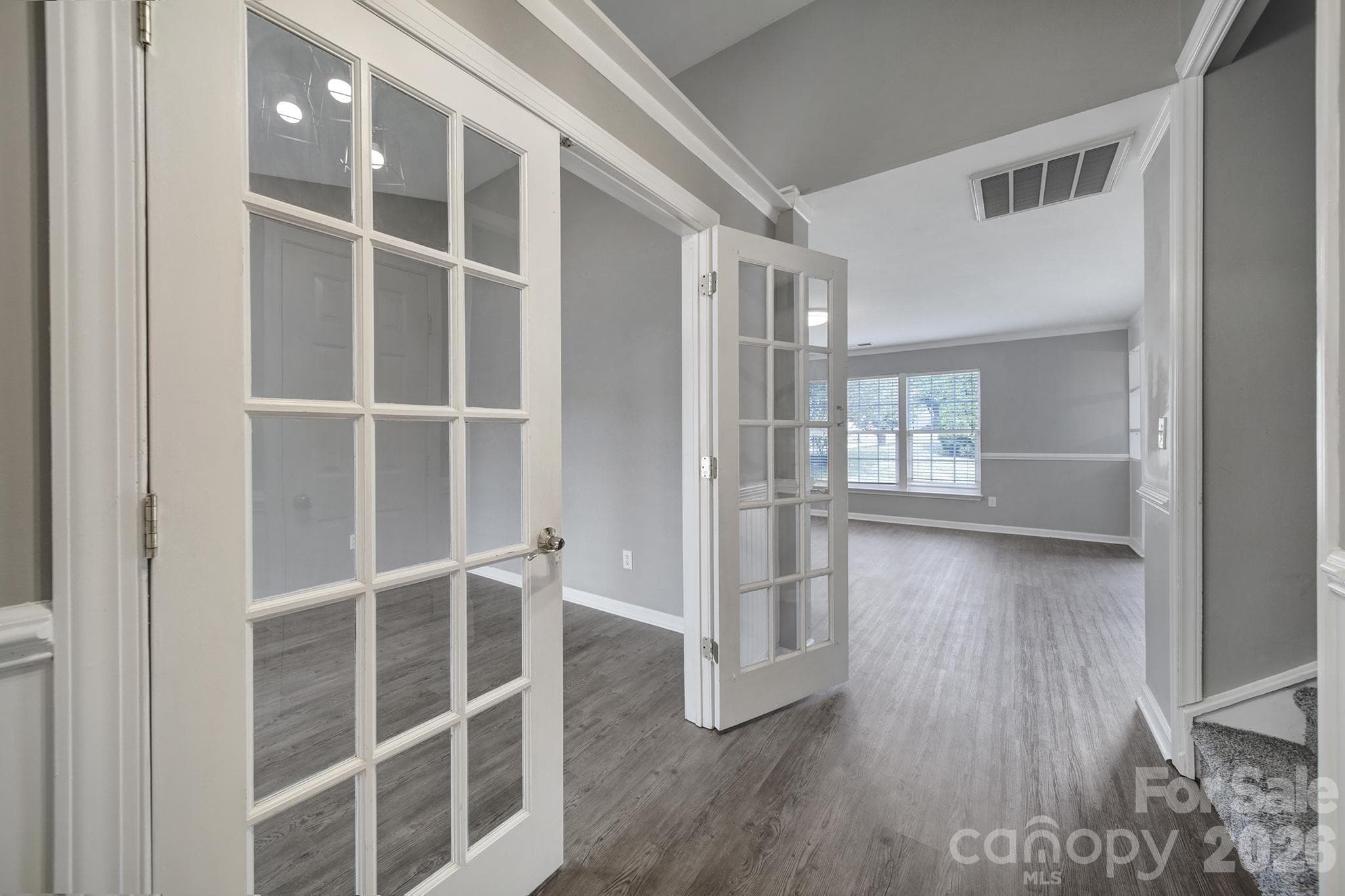 Entry hallway, office/flex room on left, coat closet and stairs on the right, family room straight ahead - 5228 Moonlight Trail SW, Concord