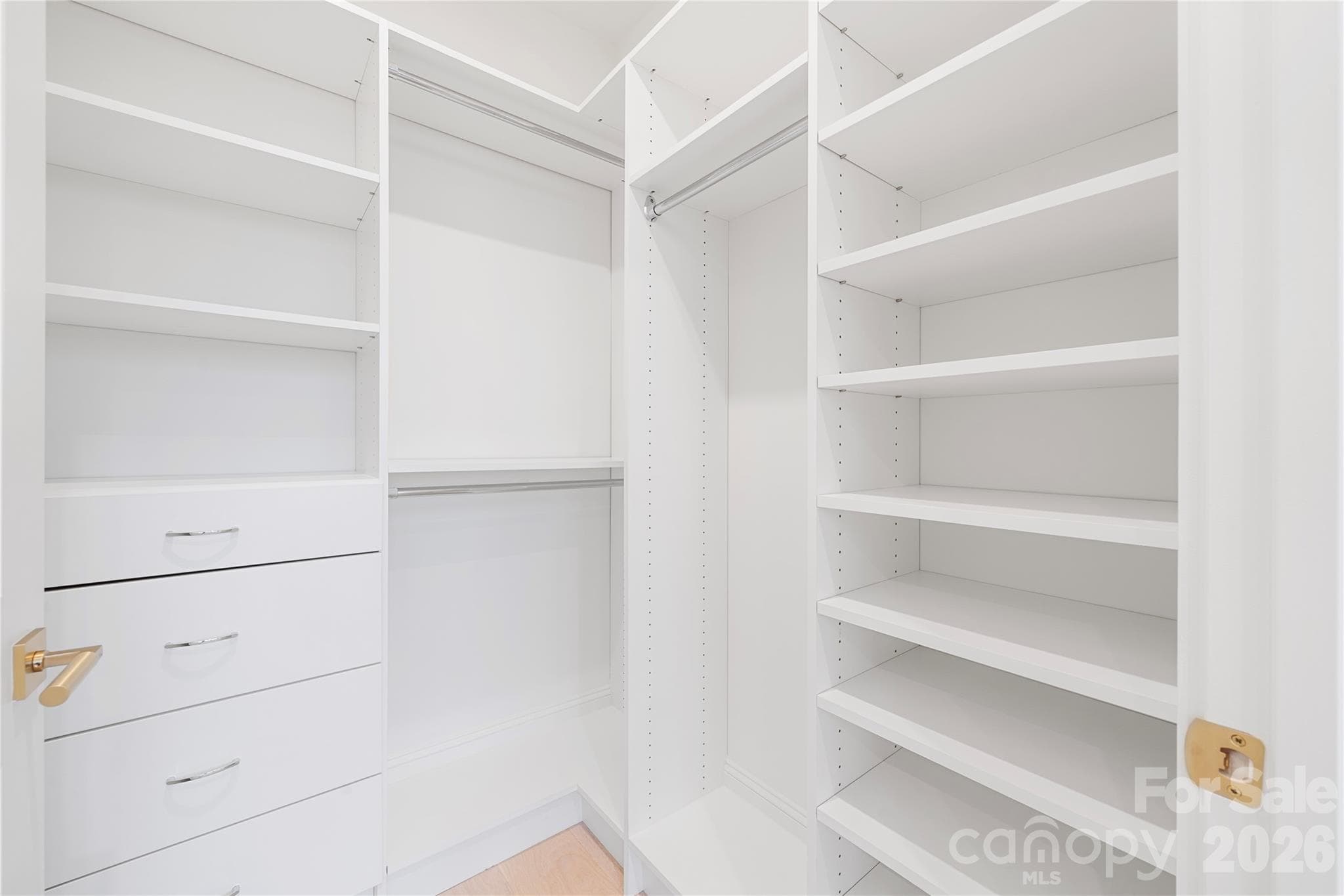 Extending Bedroom 2's suite aspect, the walk-in closet provides ample built-in shelving, drawers and hanging space. - 409 Queens Road, Charlotte