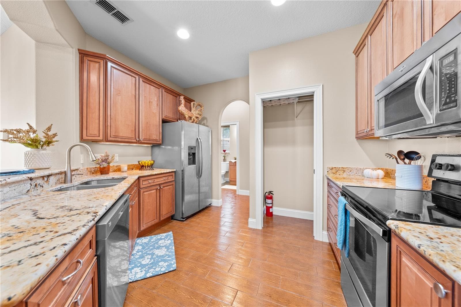 Stainless appliances and a large pantry. - 4349 PACKARD AVE, ST CLOUD
