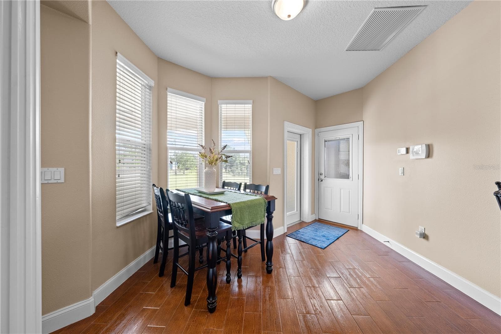 Coffee in the breakfast nook overlooking the backyard. - 4349 PACKARD AVE, ST CLOUD
