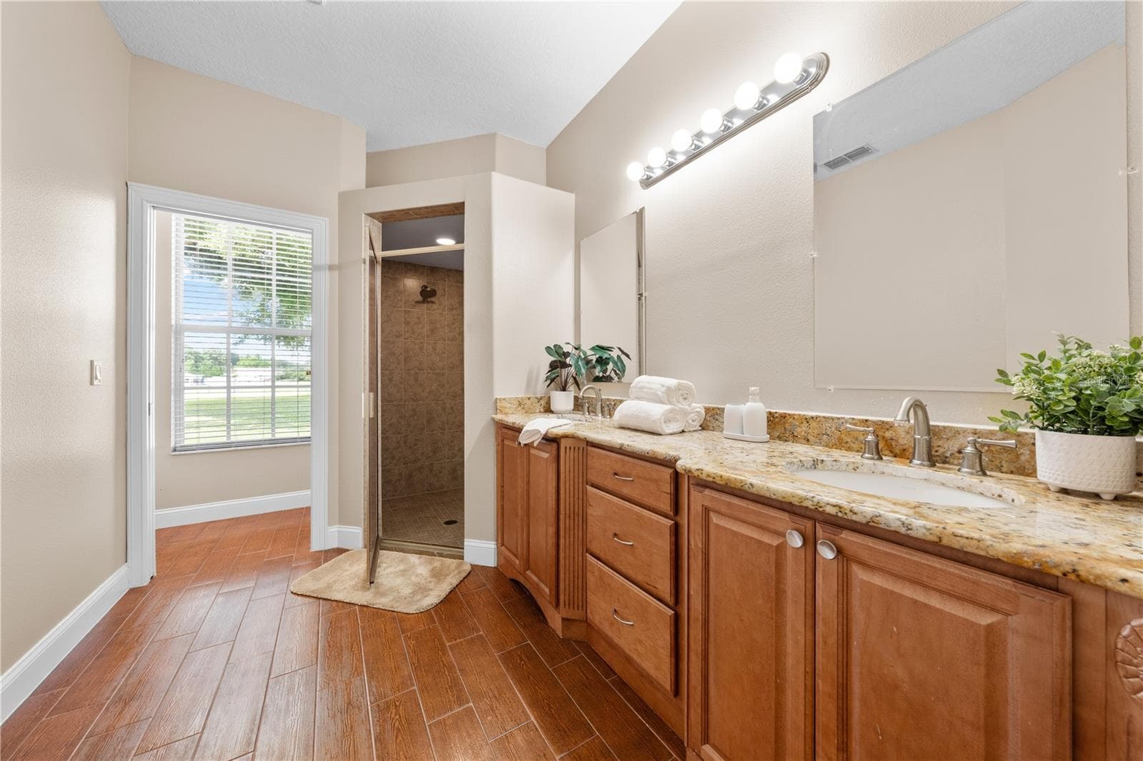 Primary Bathroom with Granite Countertops and double sinks. - 4349 PACKARD AVE, ST CLOUD