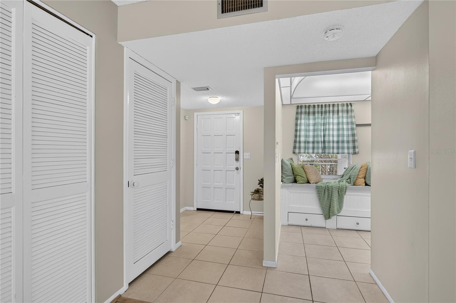 Front door and entry area to the kitchen. - 203 RUBENS DR #F, NOKOMIS