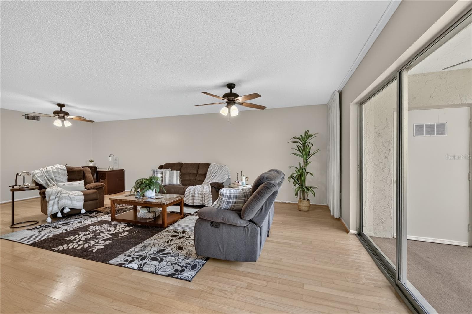 Living room Living room with sliding doors to the screened lanai. - 203 RUBENS DR #F, NOKOMIS