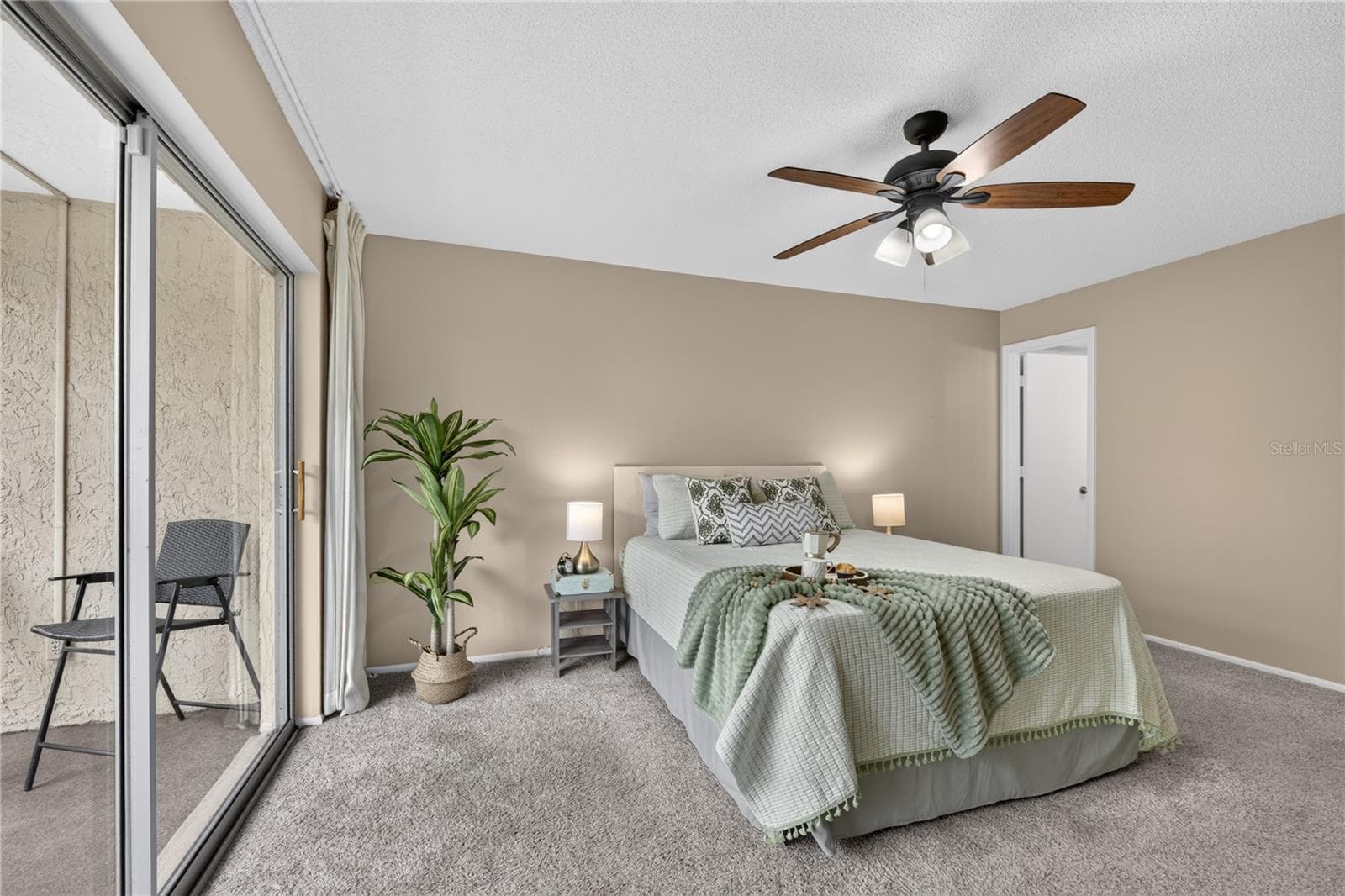 Primary bedroom with sliding doors to the screened lanai. - 203 RUBENS DR #F, NOKOMIS