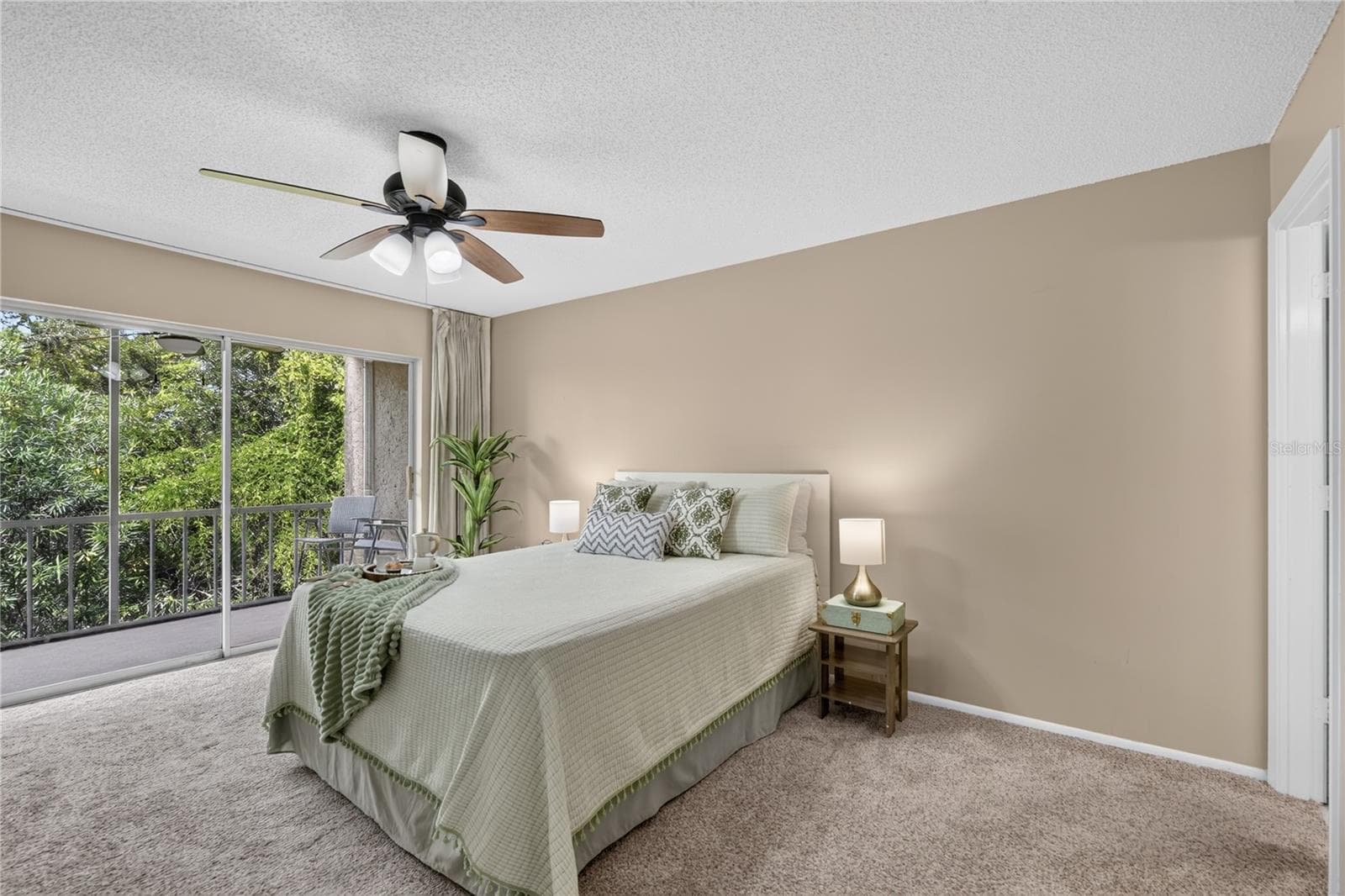 Primary bedroom  with sliding doors to the screened lanai. - 203 RUBENS DR #F, NOKOMIS