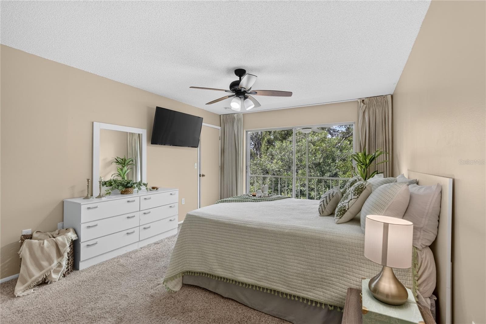 Primary bedroom  with sliding doors to the screened lanai. - 203 RUBENS DR #F, NOKOMIS