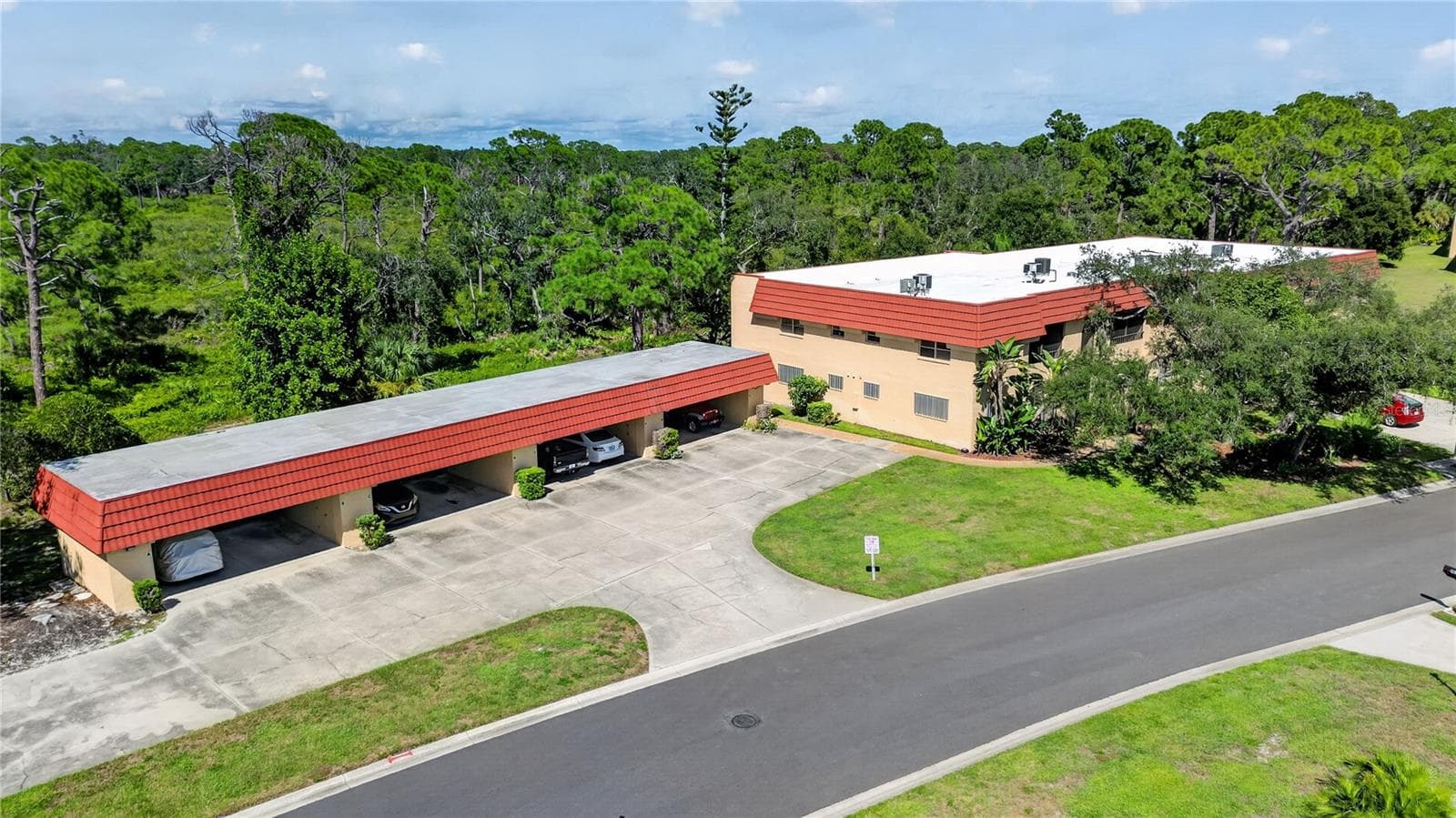 Aerial photo of the building and carport. - 203 RUBENS DR #F, NOKOMIS