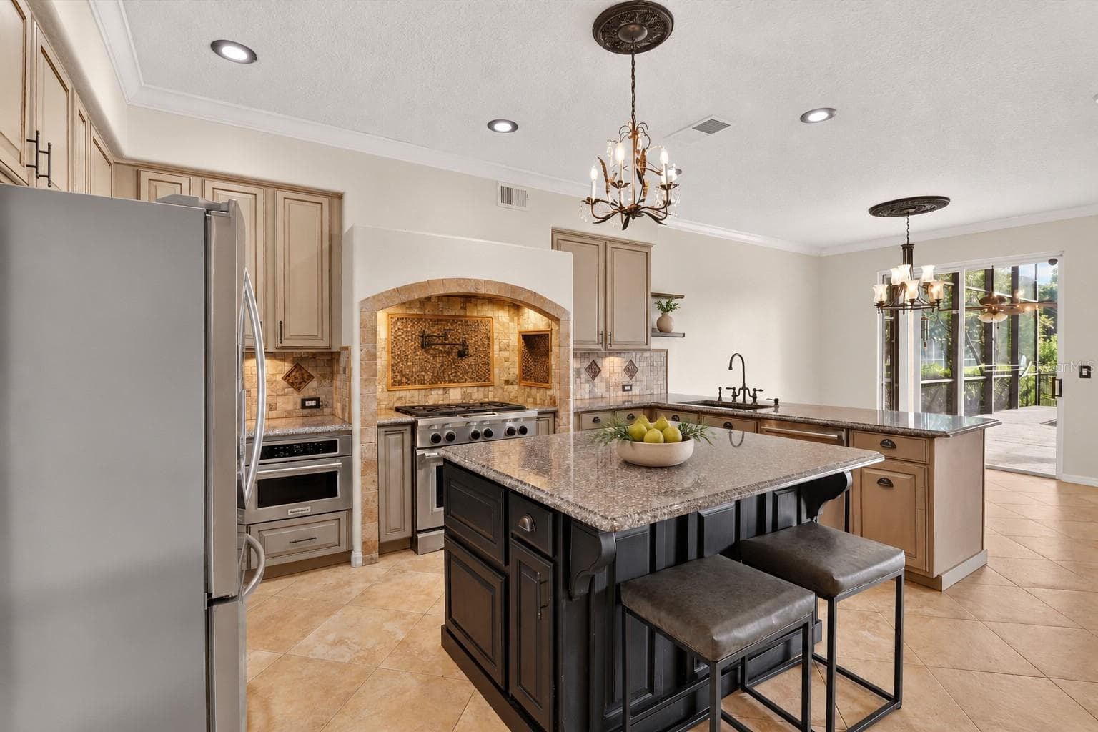 Kitchen with a large island and extensive cabinetry. - 2109 WEMBLEY PL, OVIEDO