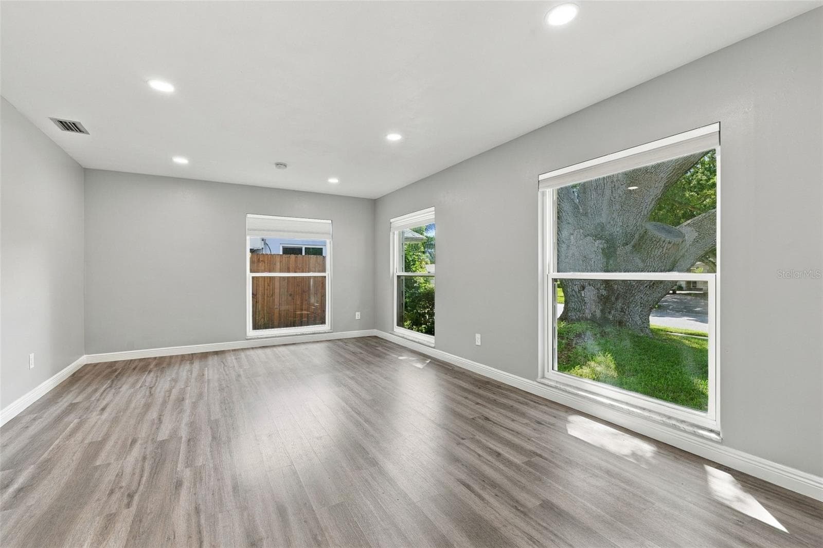 This room is across from the kitchen and enjoys views of the front yard and majestic oak tree. - 2260 SAINT CHARLES DR, CLEARWATER