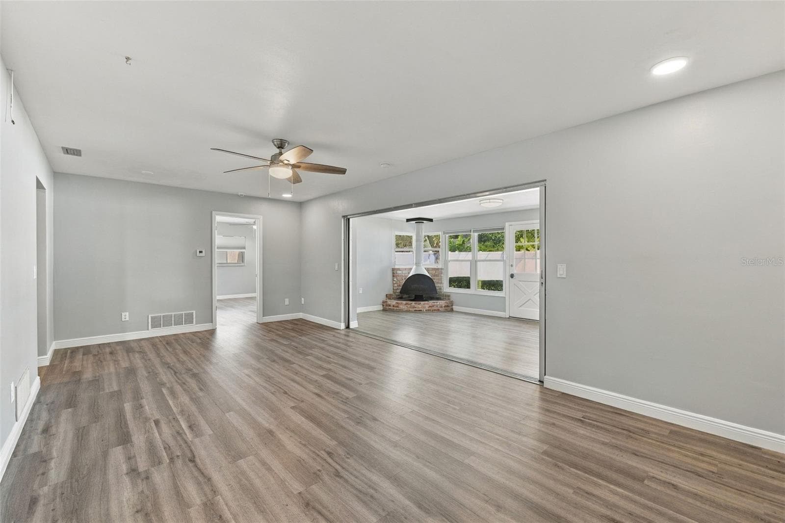 This large room off the kitchen also opens up to the Florida room and fireplace. The door on the far wall is to the primary bedroom and ensuite bathroom. - 2260 SAINT CHARLES DR, CLEARWATER