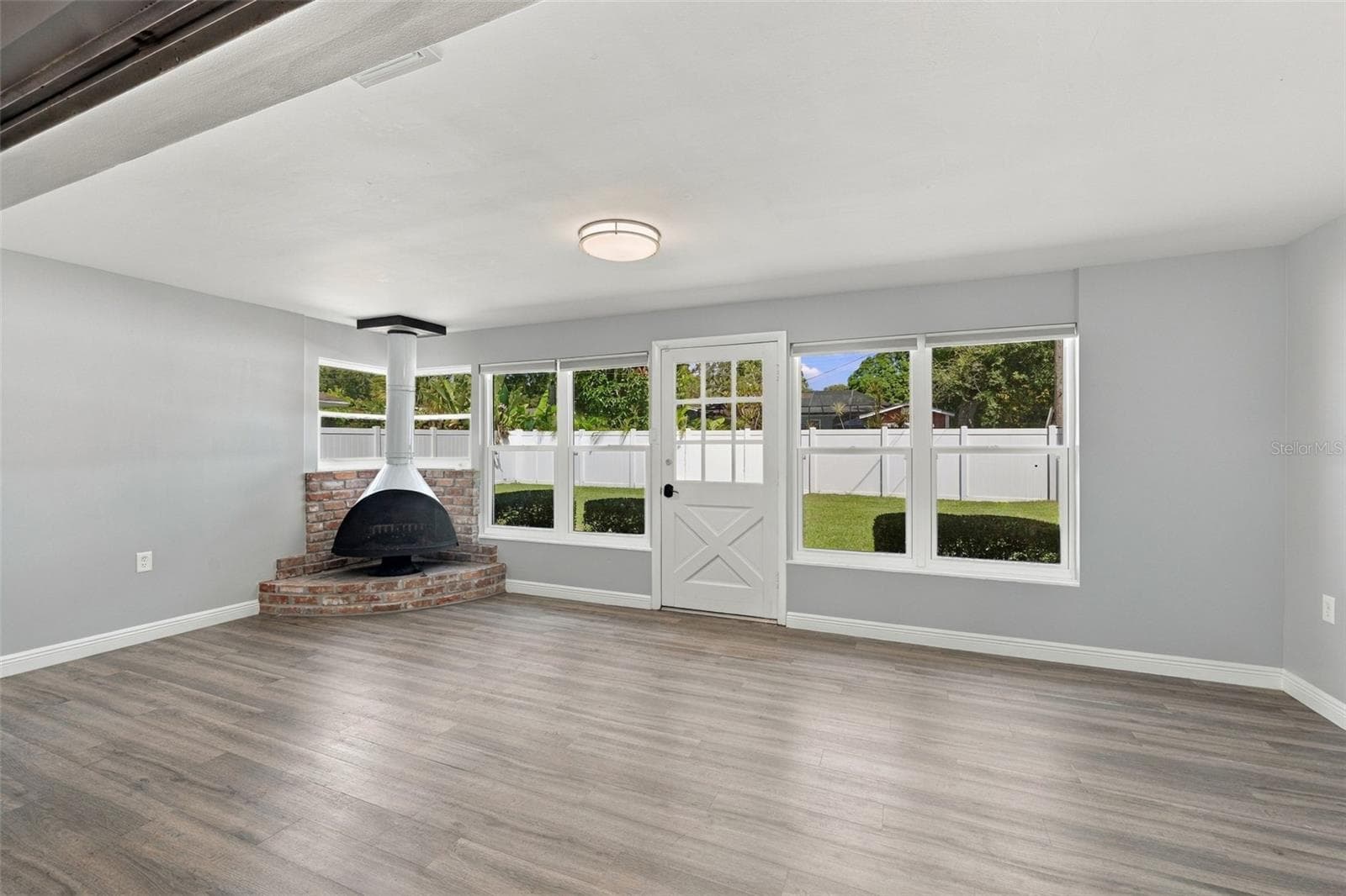 Enjoy tons of natural light and views into your private backyard along with a working fireplace. - 2260 SAINT CHARLES DR, CLEARWATER