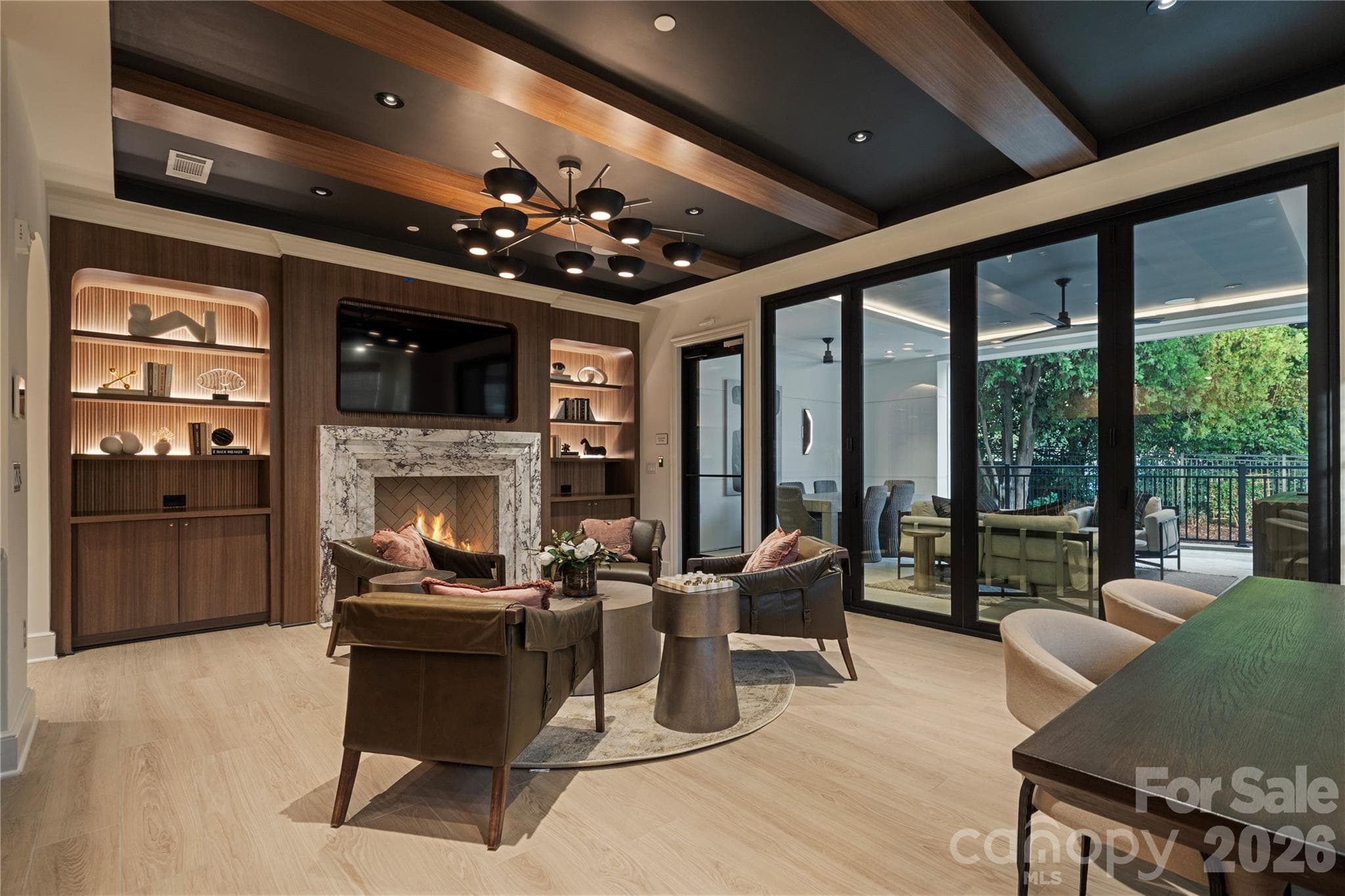 Within the larger condominium complex, the sophisticated main floor Residents Club provides a wonderful respite with rich wood finishes, a marble fireplace, built-in bar and direct access to the covered porch and outdoor gathering area. - 409 Queens Road, Charlotte