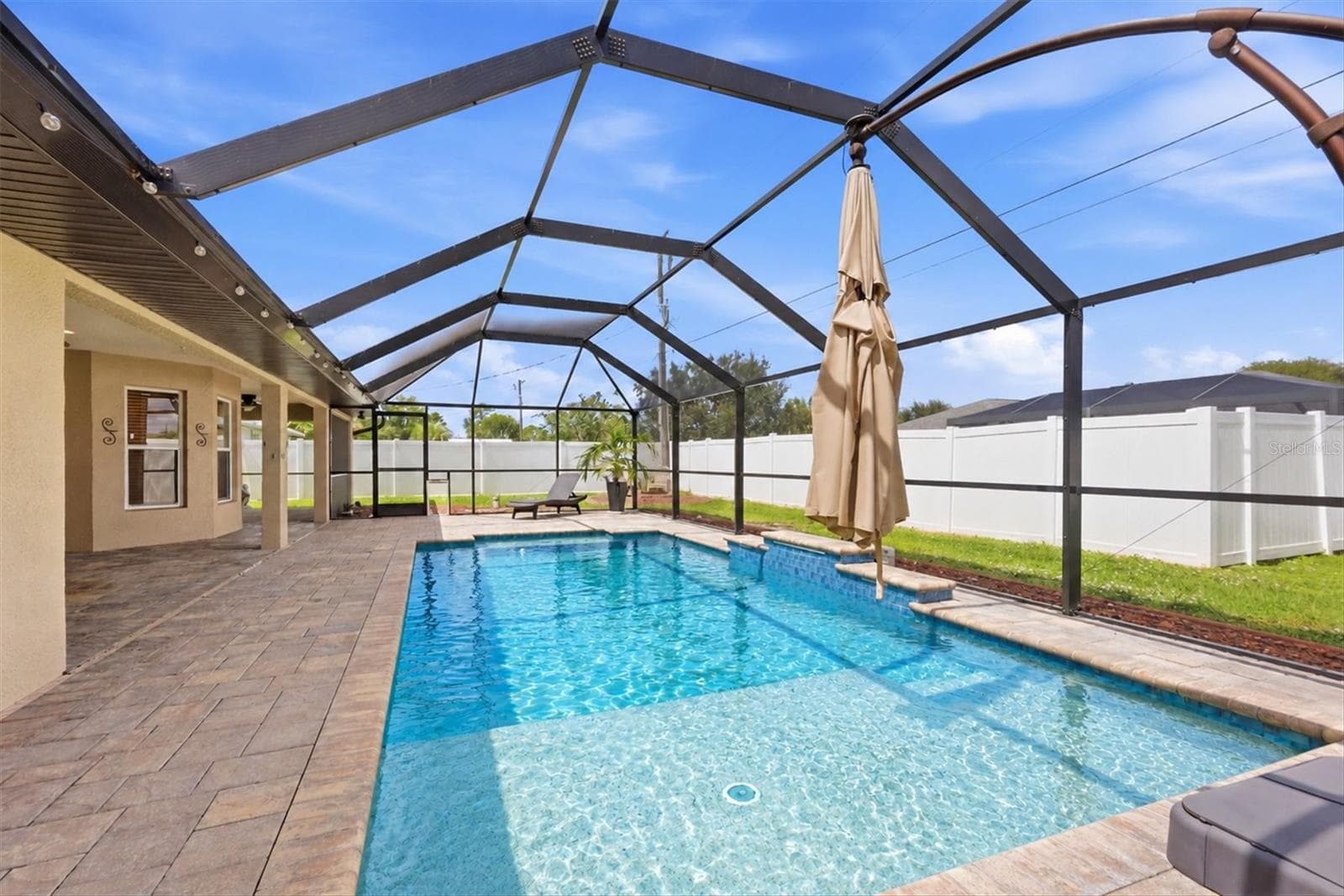 lounger area at far end of pool and beach entrance forward in photo - 23108 AUGUST AVE, PORT CHARLOTTE