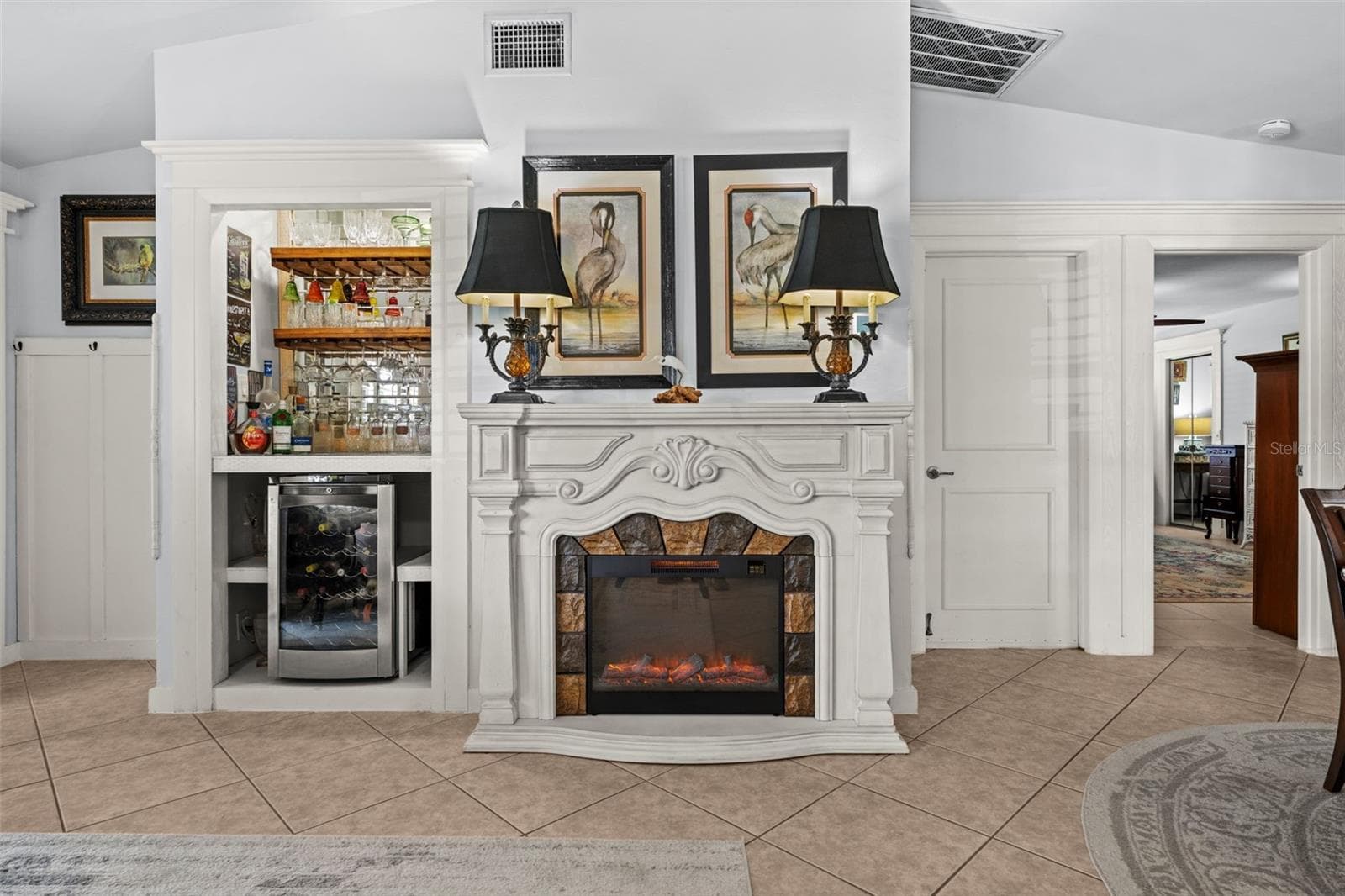 There's even a fireplace and a wine bar with fridge in the living room! - 427 SW 34TH ST, CAPE CORAL