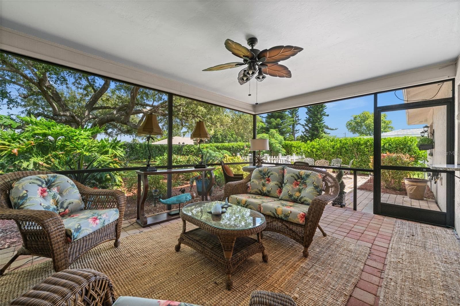 Screened lanai with paver floor overlooking the lush backyard - 427 SW 34TH ST, CAPE CORAL