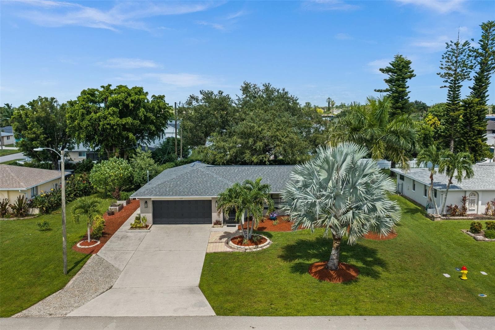 Surrounded by lush landscaping - 427 SW 34TH ST, CAPE CORAL