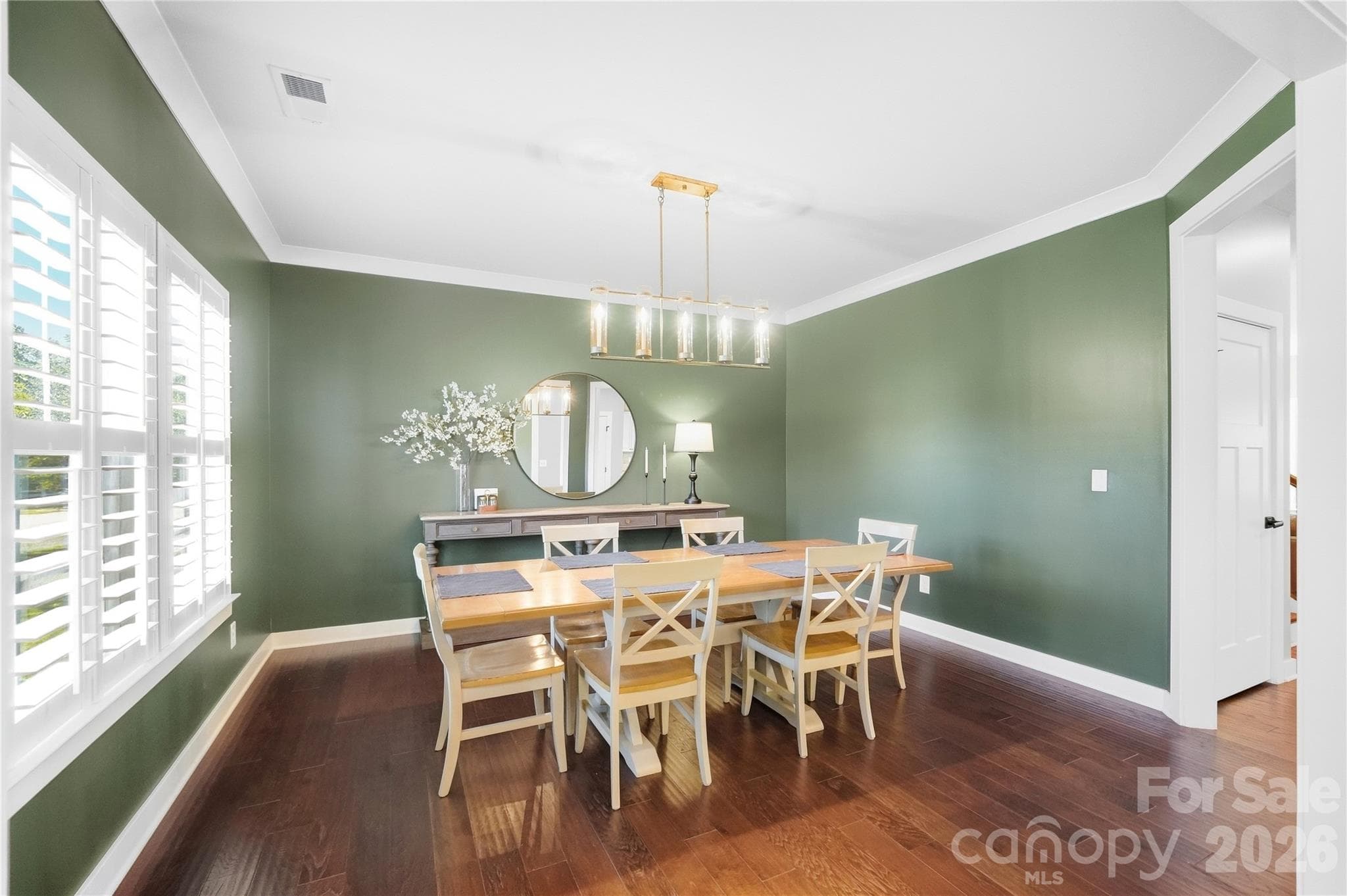 Welcoming foyer with hardwood floors, crown molding, and wide cased openings to the formal dining room and the den/second office. - 912 Manorwood Drive, Waxhaw
