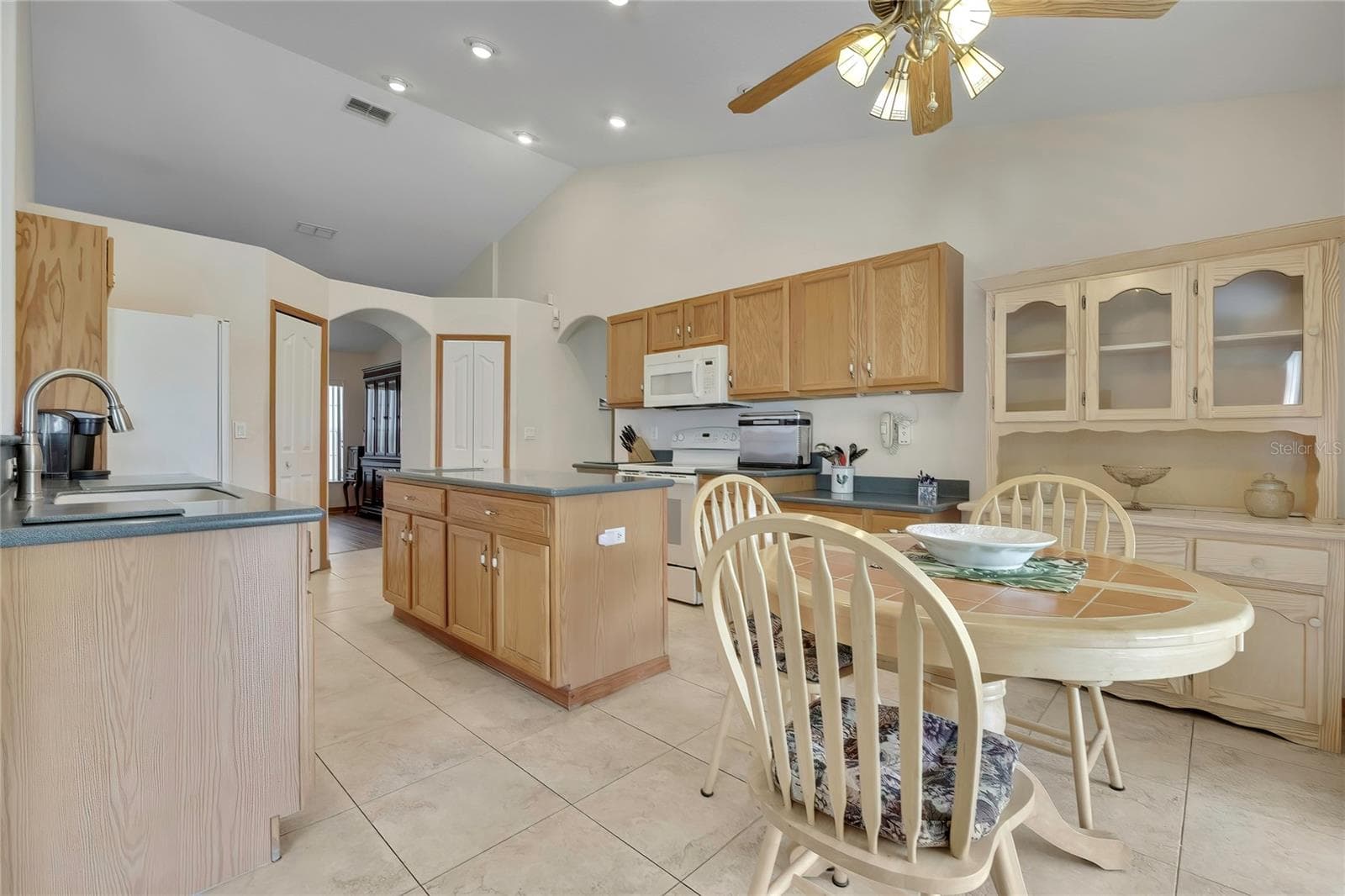 Open concept kitchen with center island and dining area - 4583 GONDOLIER RD, SPRING HILL