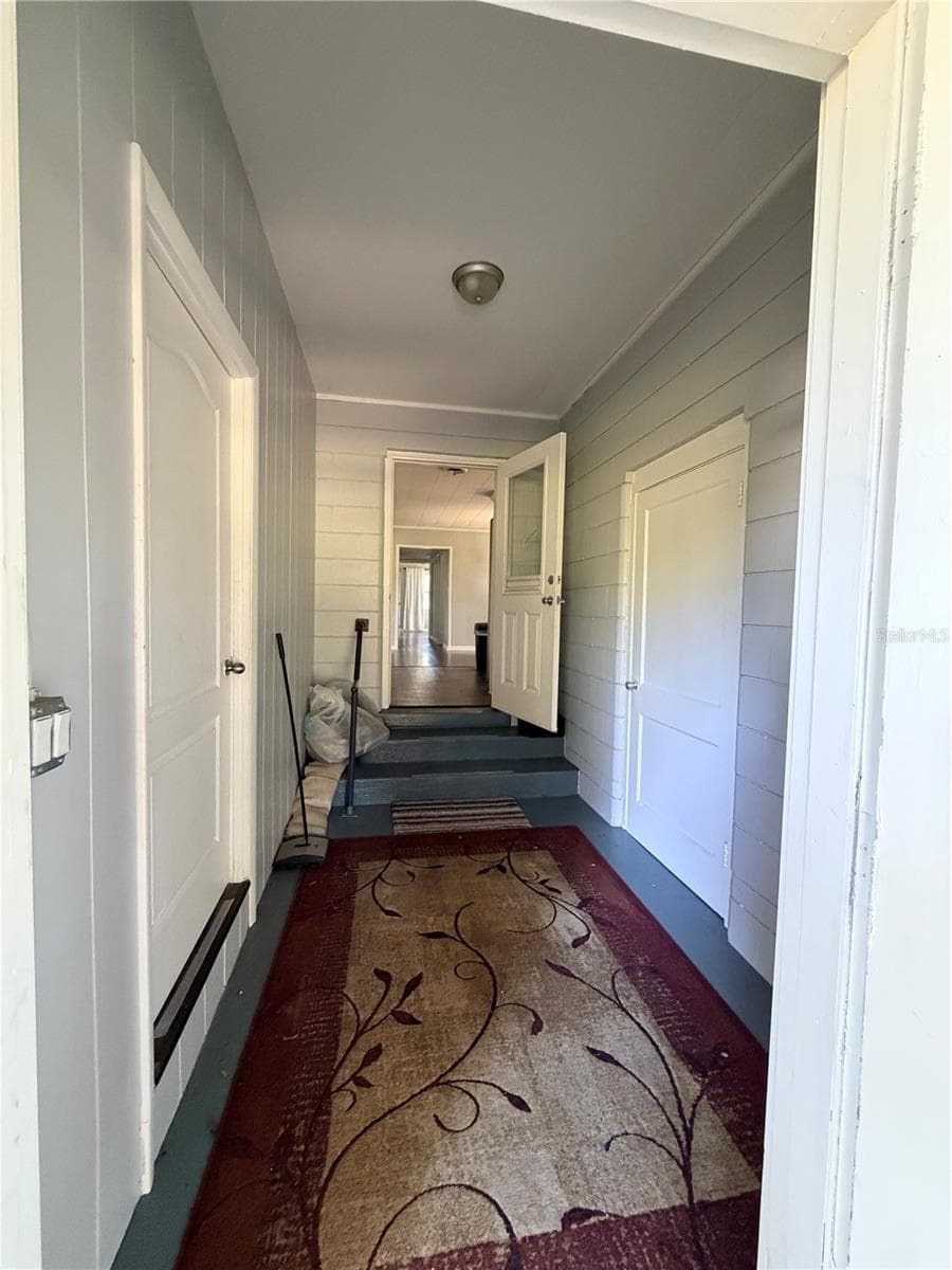 Entrance from carport. Laundry on right, 4th b/r on left - 1774 NE 12TH ST, OCALA