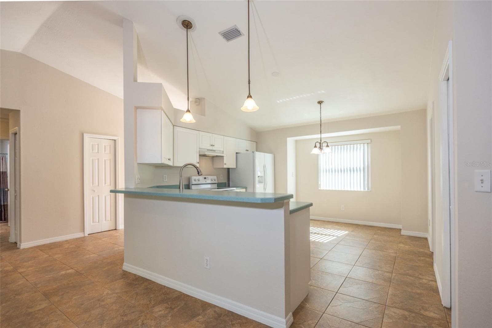 The kitchen is adjacent to the living room. To the left is a storage closet in the Foyer. - 141 BREN MAR LN, PALM COAST