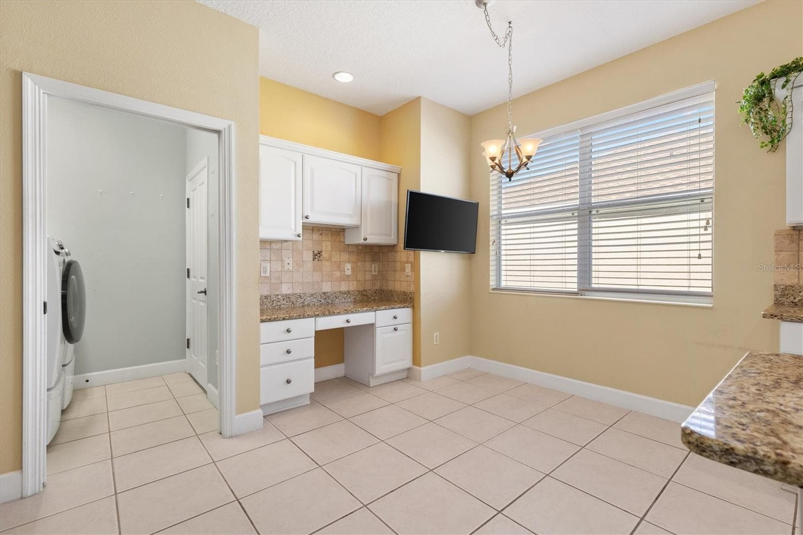 CONVENIENT DESK AREA WITH LARGE TV*CONVEYS WITH SWIVEL TV MOUNT - 1025 WINNSBORO DR, THE VILLAGES
