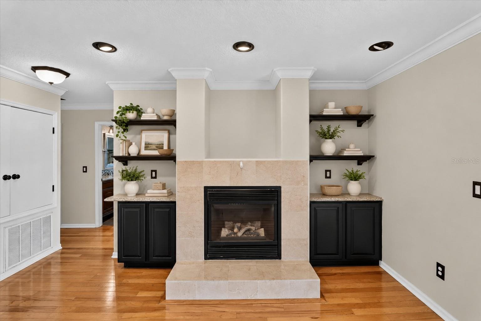 Loft fireplace framed by built-in cabinetry and display shelves. - 2109 WEMBLEY PL, OVIEDO