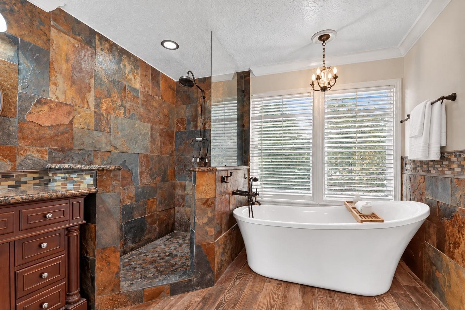 Primary bathroom with a freestanding soaking tub and oversized tiled shower. - 2109 WEMBLEY PL, OVIEDO